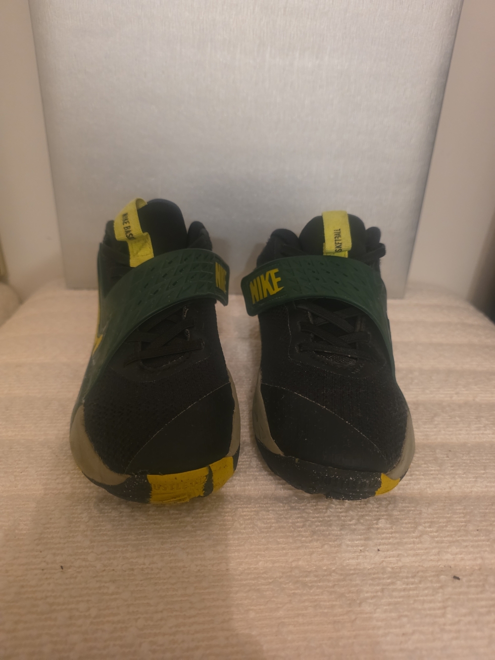 Nike Team Hustle youth basketball shoes in black, green, and yellow. Size 1Y